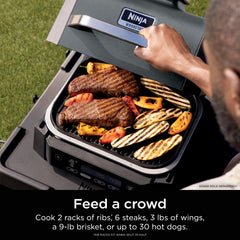 Ninja Woodfire open grill searing steaks for rich char and faster cooking