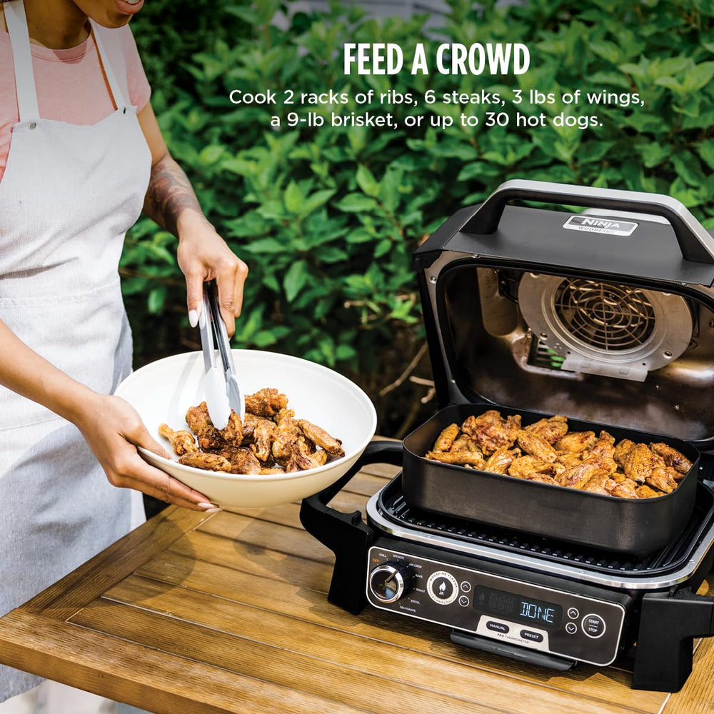 Ninja Woodfire Pro in backyard cookout setting demonstrating convenient outdoor entertaining