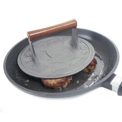 Norpro bacon press in skillet flattening bacon for faster, even browning