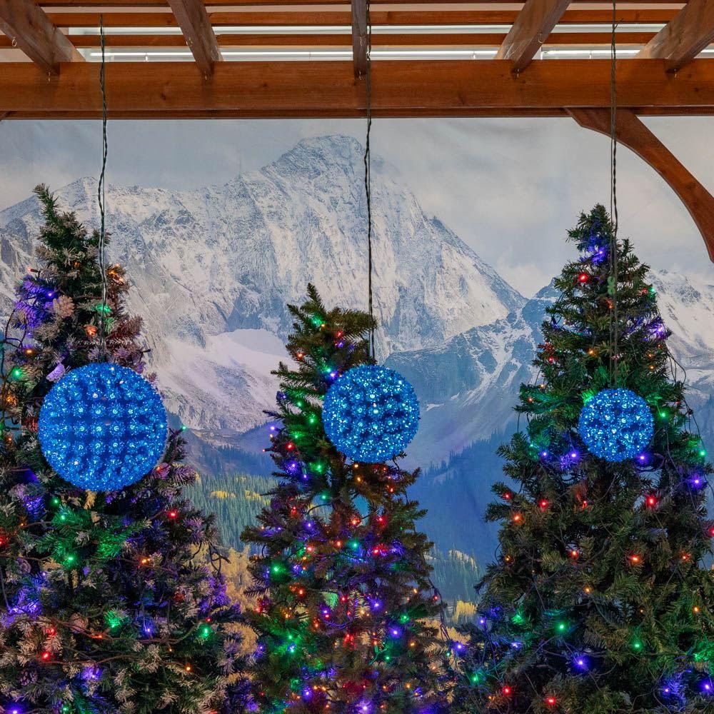 Novelty Lights lit sphere in yard at night creating ambient blue outdoor lighting