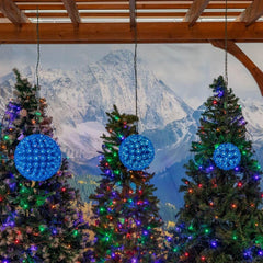 Novelty Lights lit sphere in yard at night creating ambient blue outdoor lighting