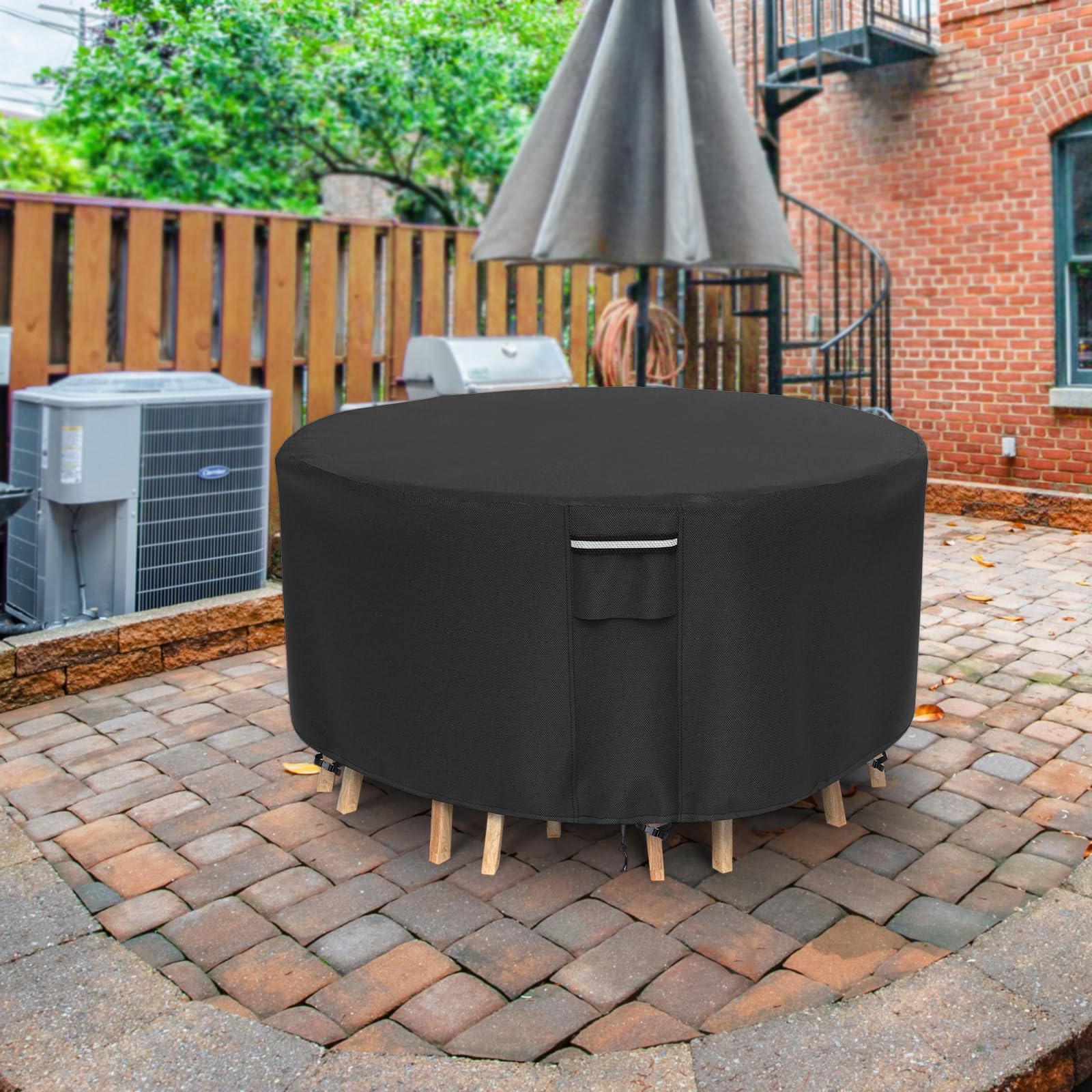 NYFITY cover next to chair for scale showing fit for sets up to 82 inches diameter