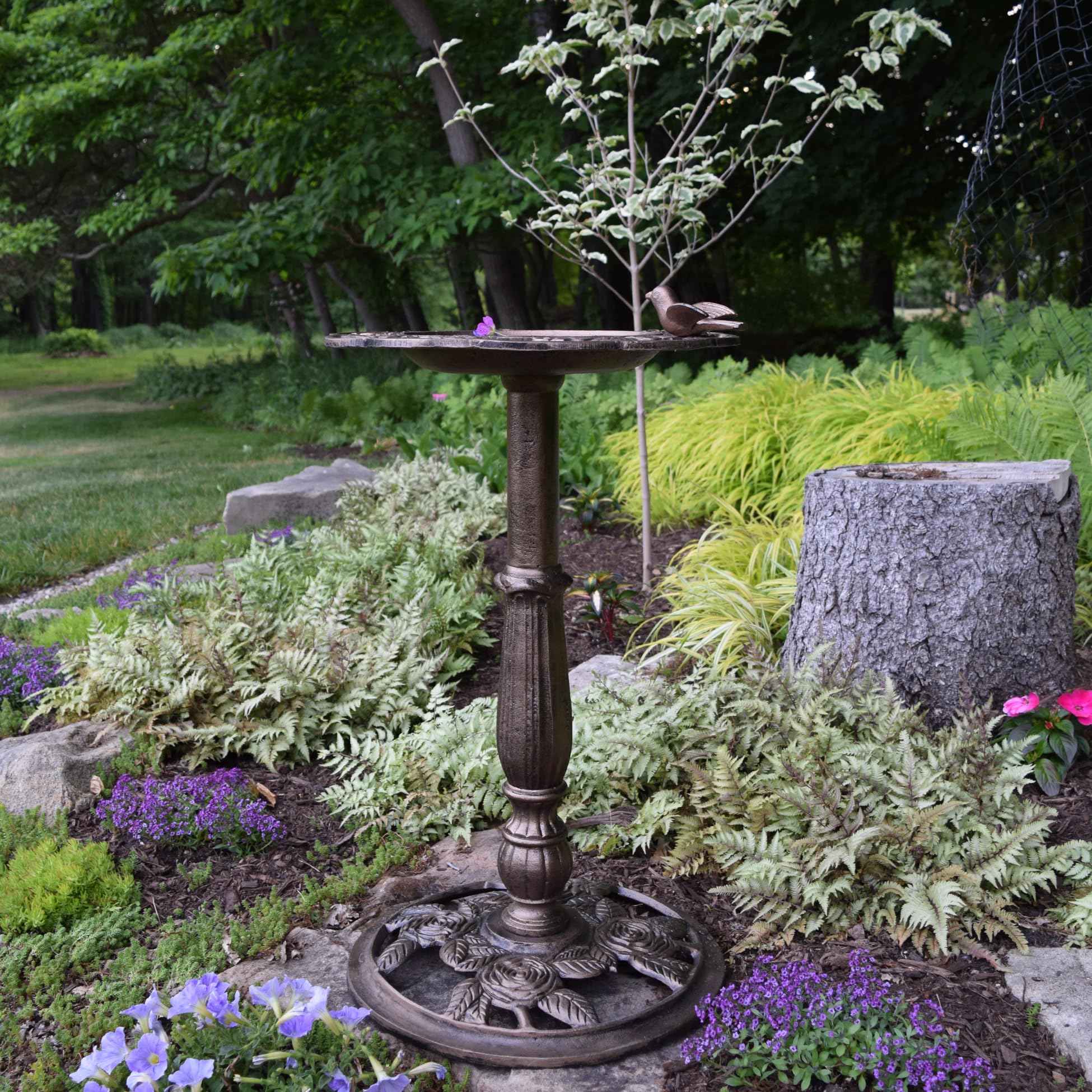 Oakland Living bird bath in garden setting showing how it enhances landscape