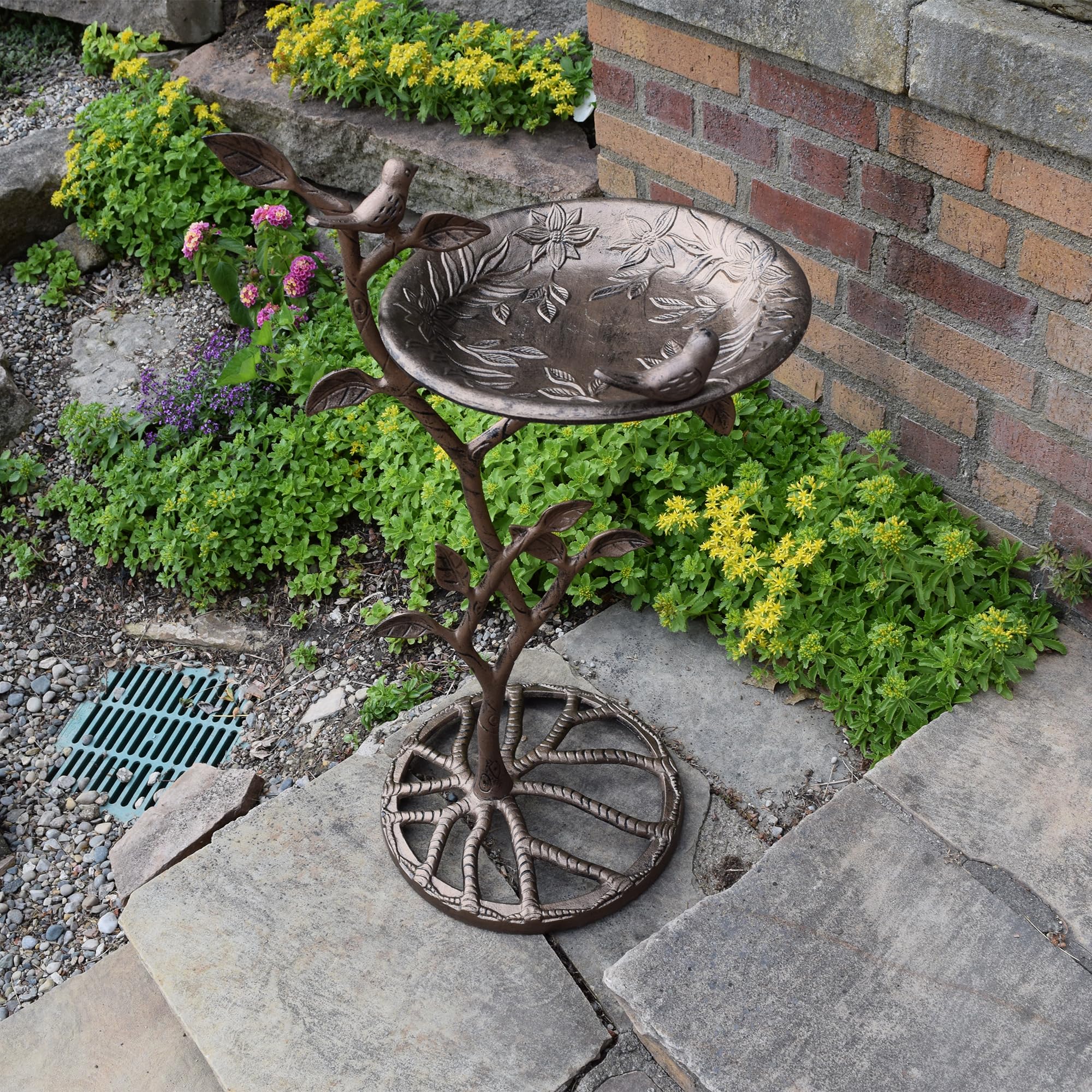 Oakland Living bird bath next to a chair showing scale and patio suitability