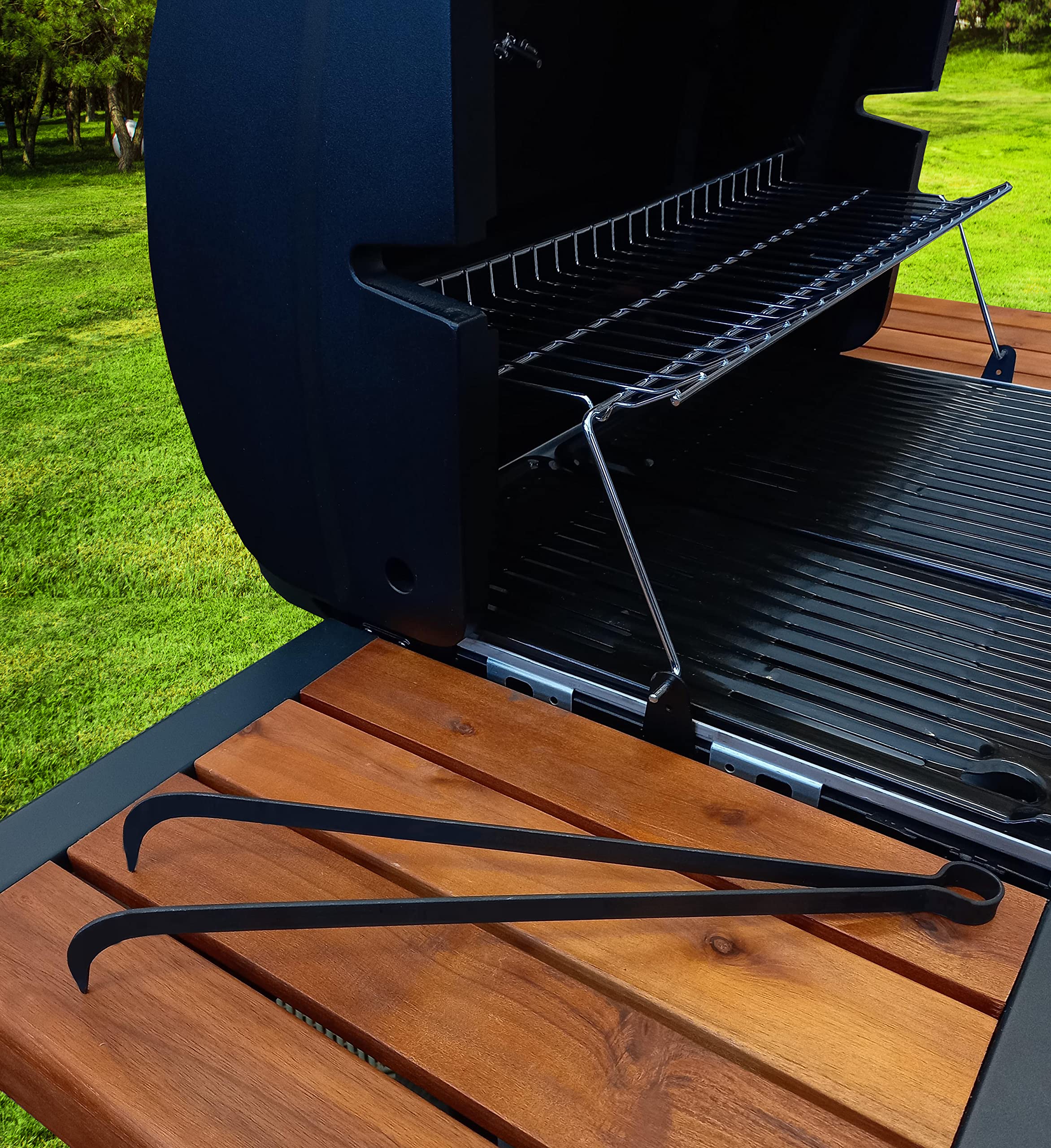 OC TRADE tongs in use moving hot coals on a grill for safer handling