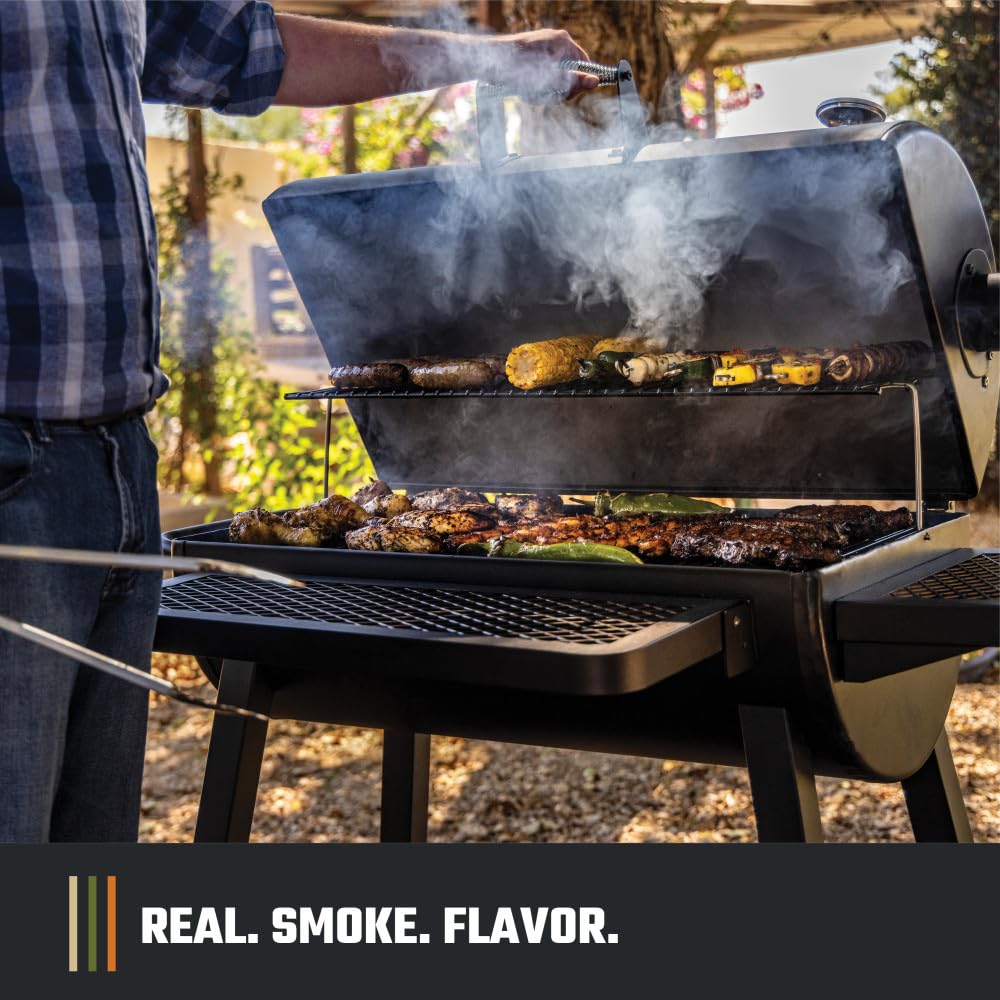 Oklahoma Joe's grill next to person showing scale and large cooking capacity benefit