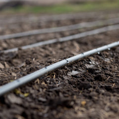 One Stop Outdoor tubing installed in garden bed demonstrating even watering coverage