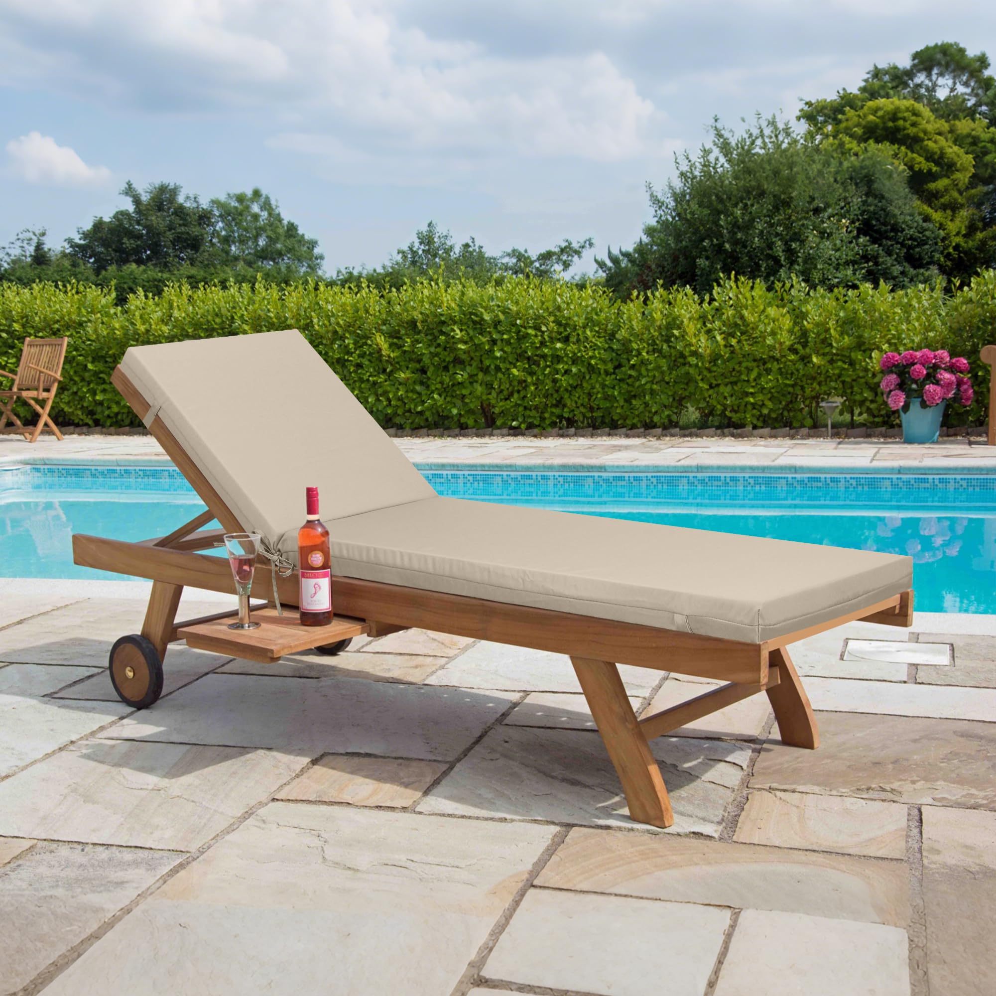 Only choice khaki cushions on poolside chaise in a backyard scene, conveys weather-ready relaxation
