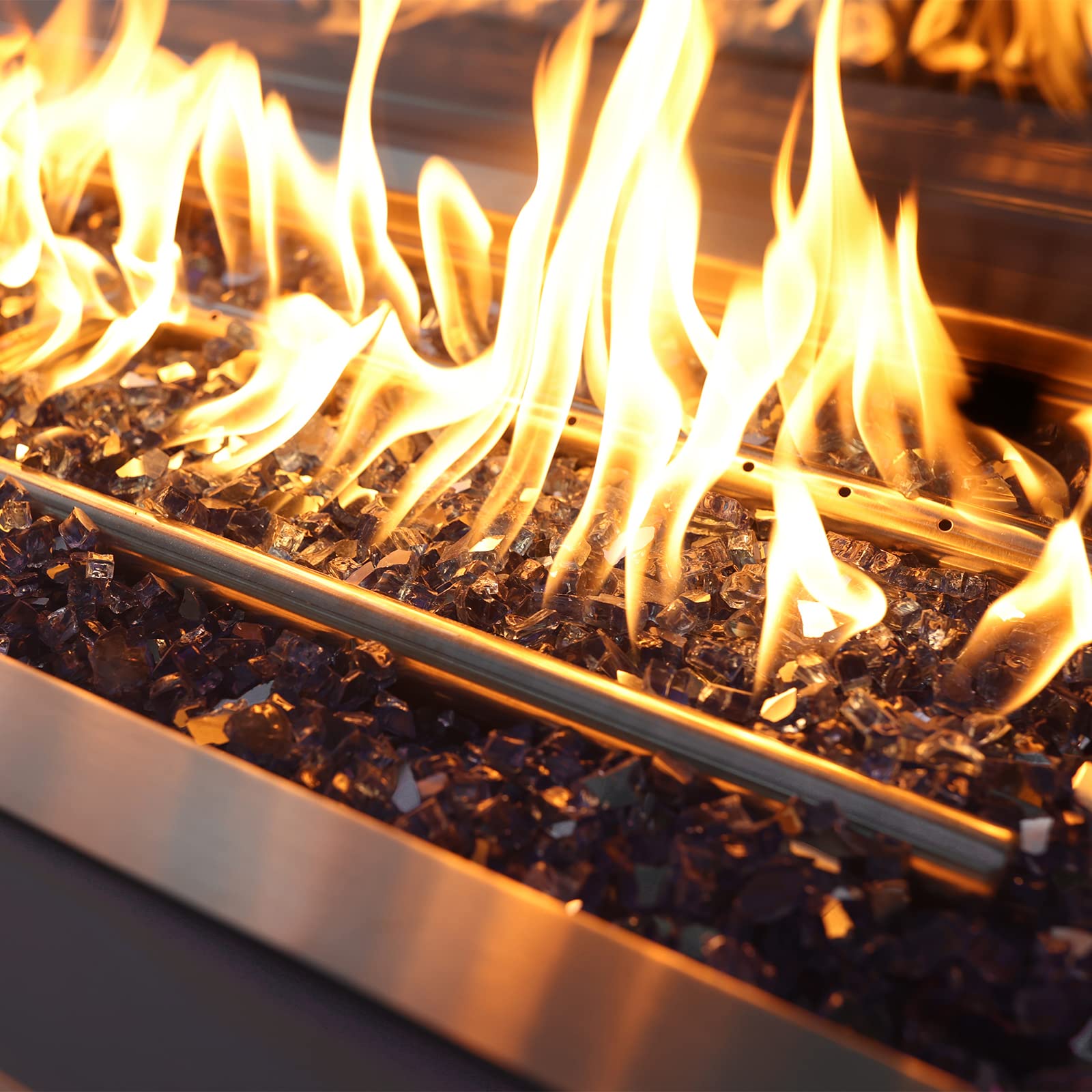 Onlyfire glass in a propane fire pit creating vivid flame reflections