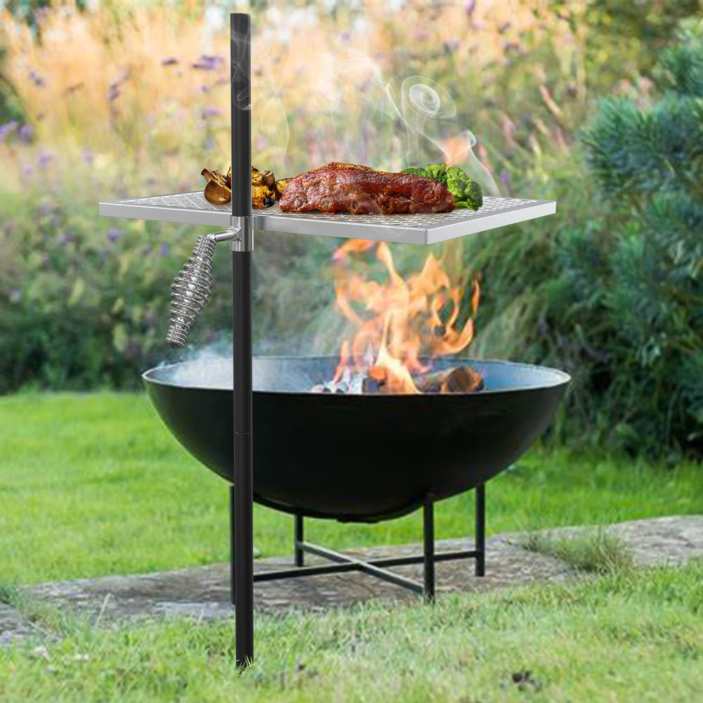onlyfire grate beside hands illustrating scale and easy ground-stake setup