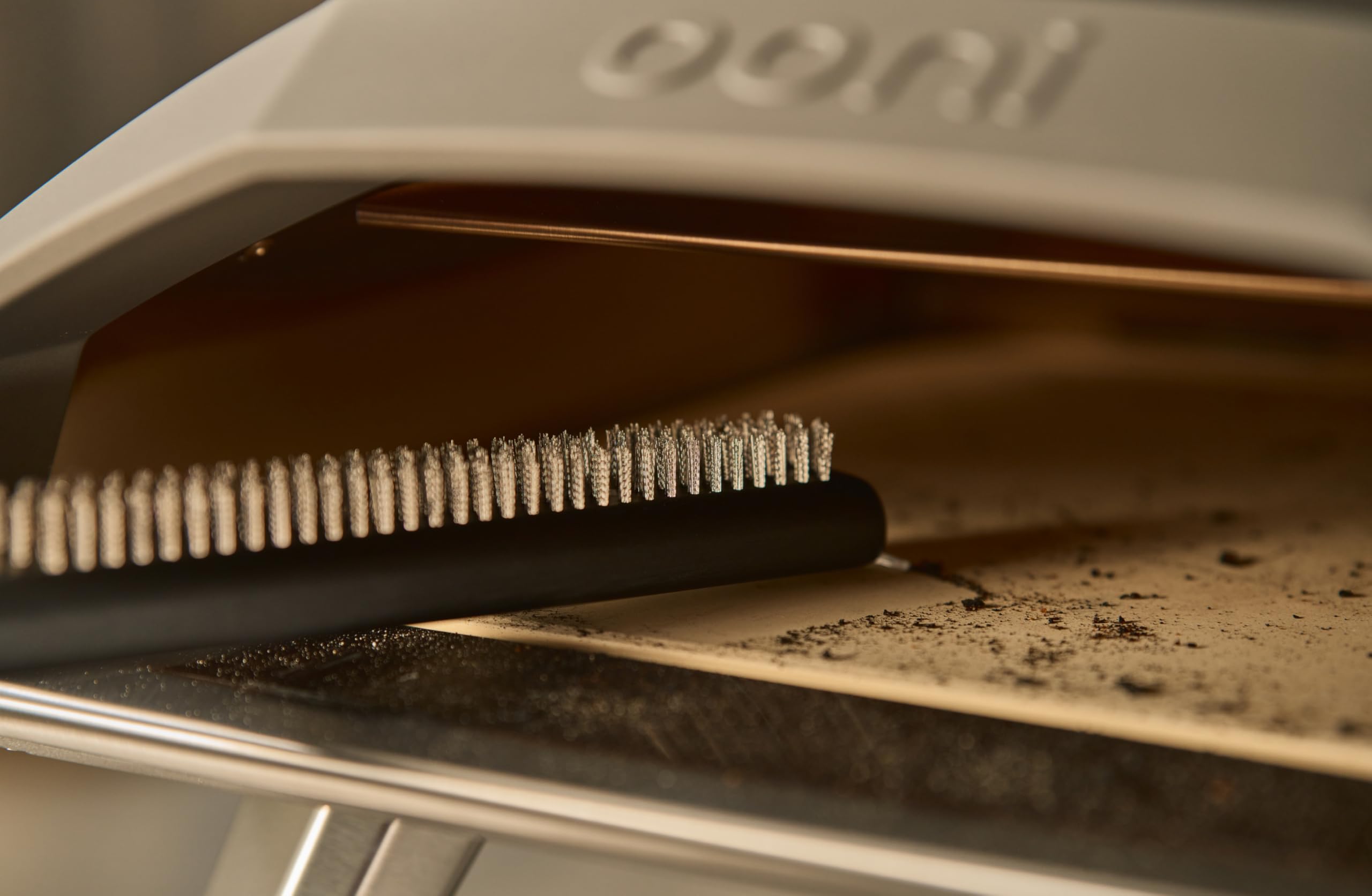 ooni brush hung on table hook for tidy accessible outdoor storage