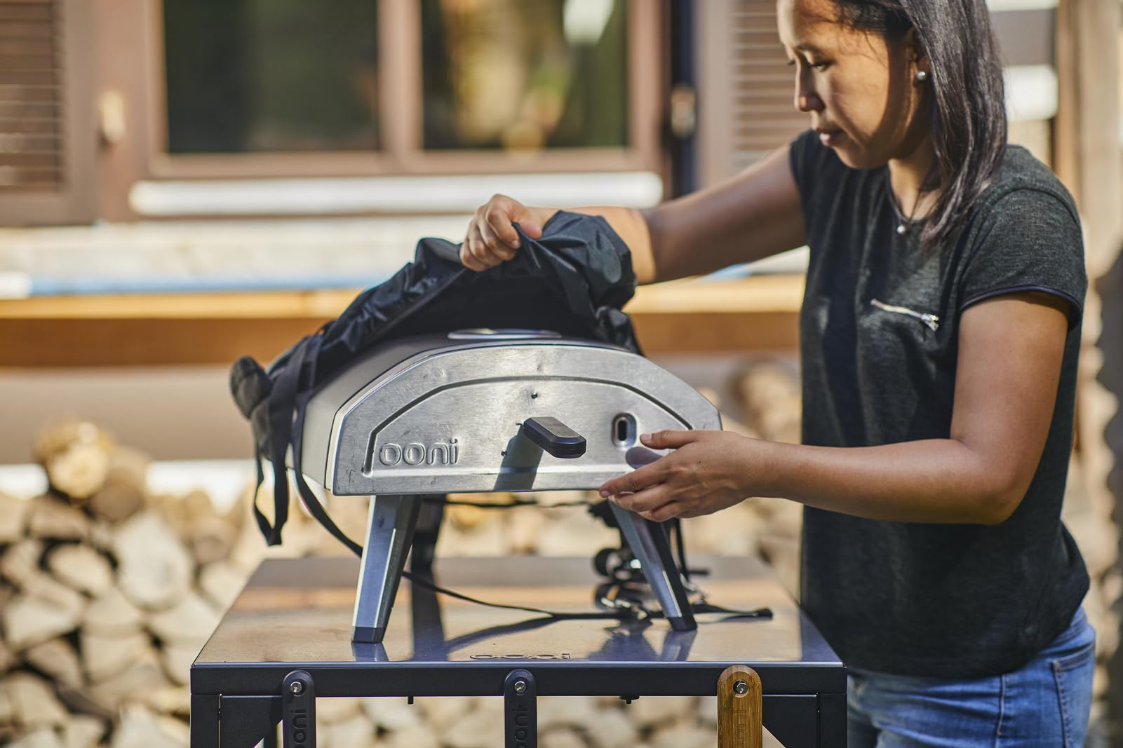 ooni Fyra 12 being carried by two people for easy transport