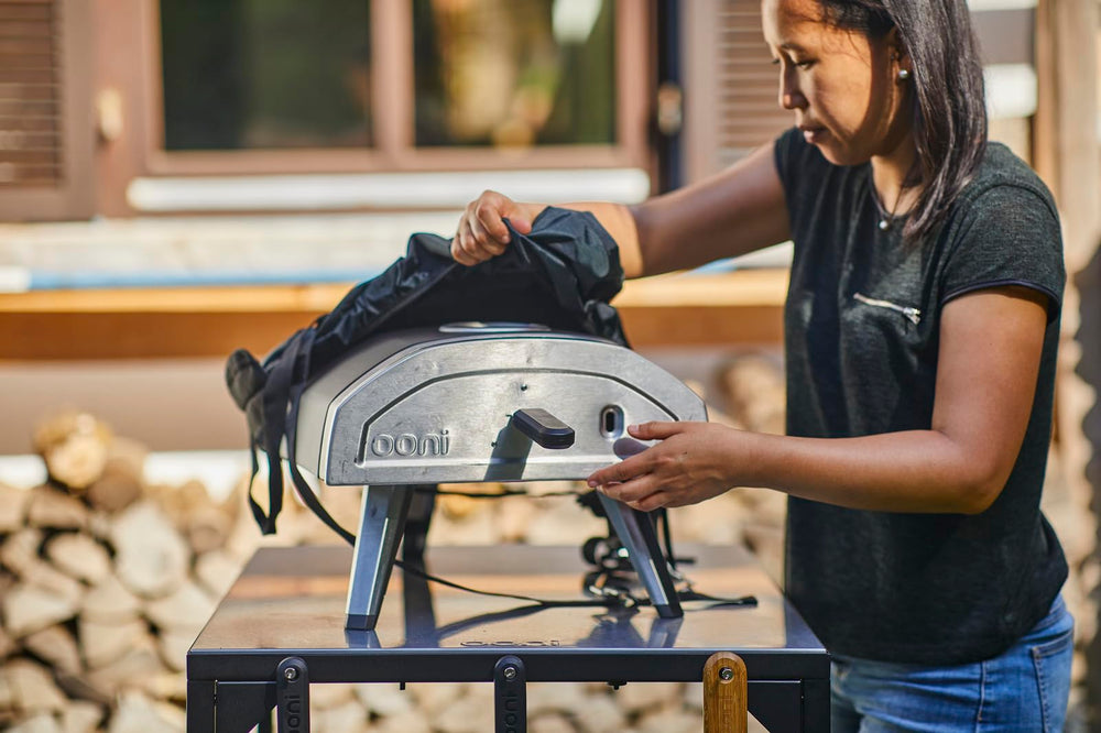 ooni Fyra 12 being carried by two people for easy transport