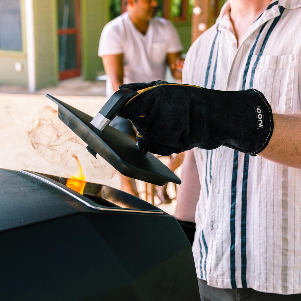 ooni gloves handling hot grill grate offering secure, heat‑resistant grip