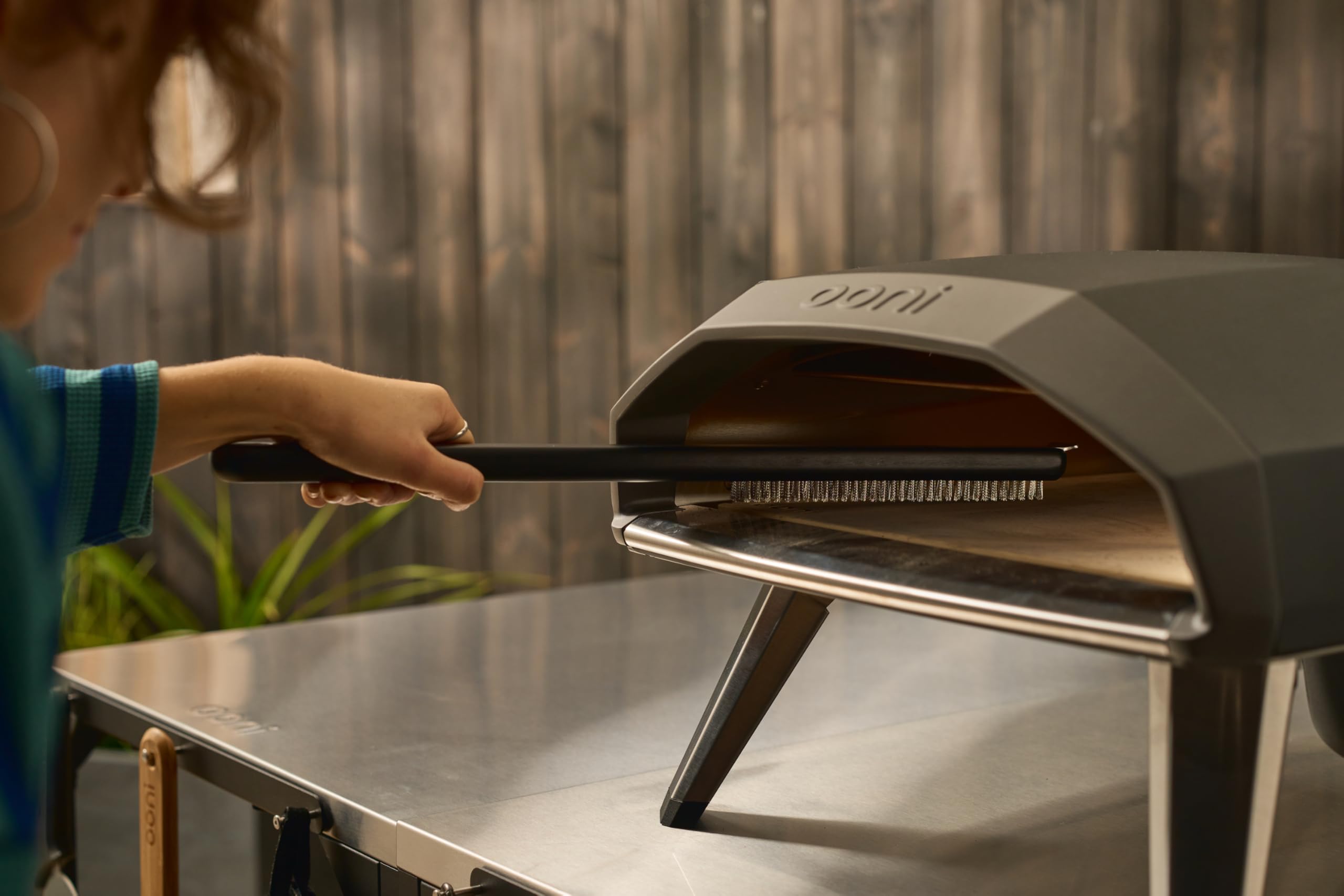 ooni brush in oven cleaning action demonstrating precise corner access