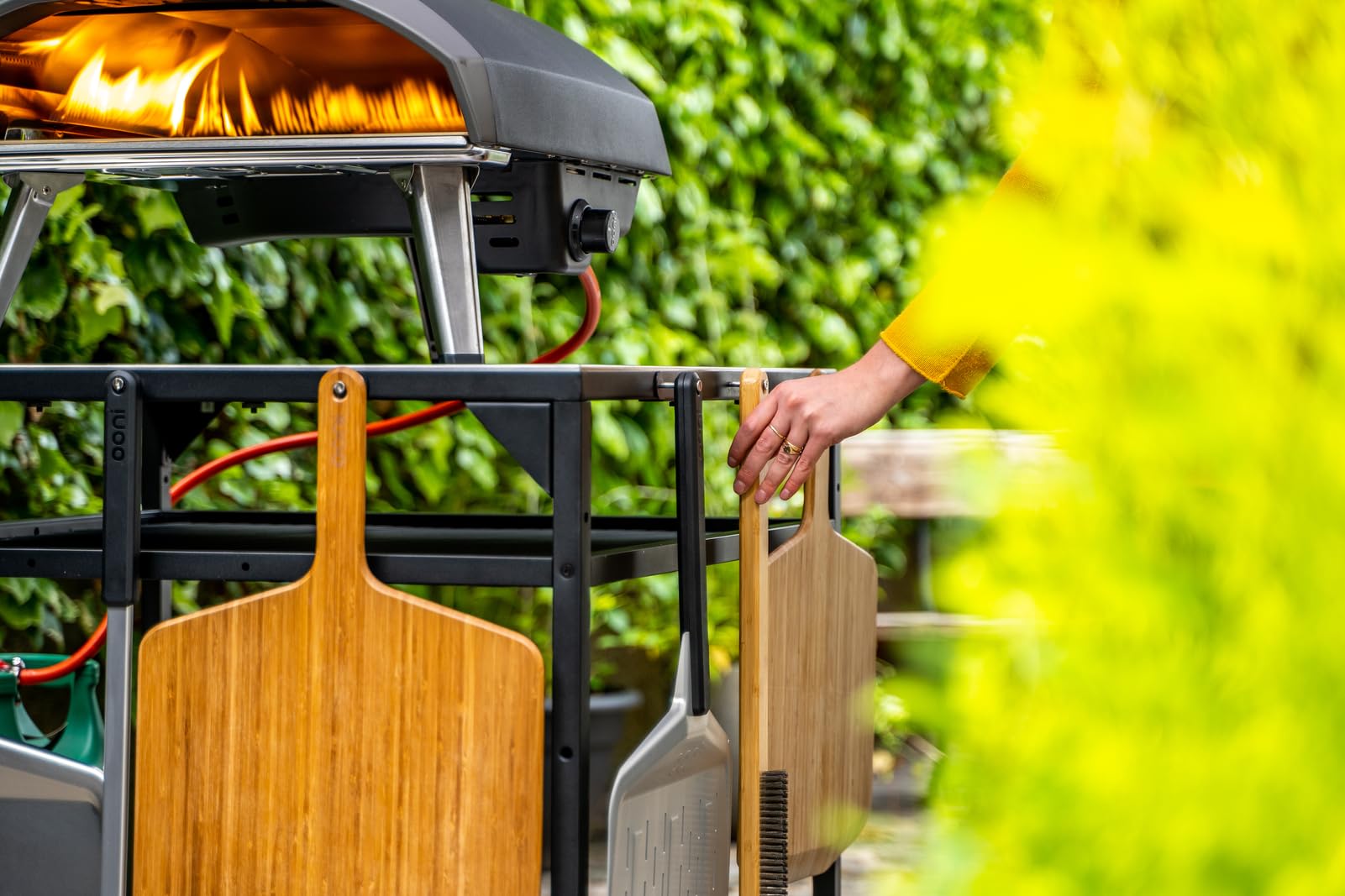 ooni pizza oven brush lifestyle backyard setting demonstrating portability and outdoor convenience