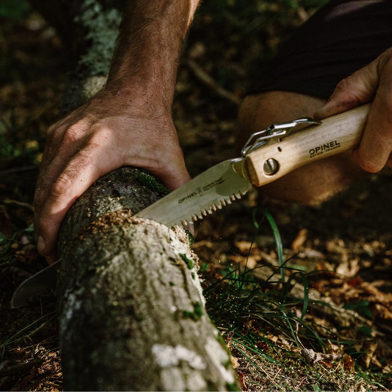 OPINEL saw cutting a branch outdoors, fast pruning made simple