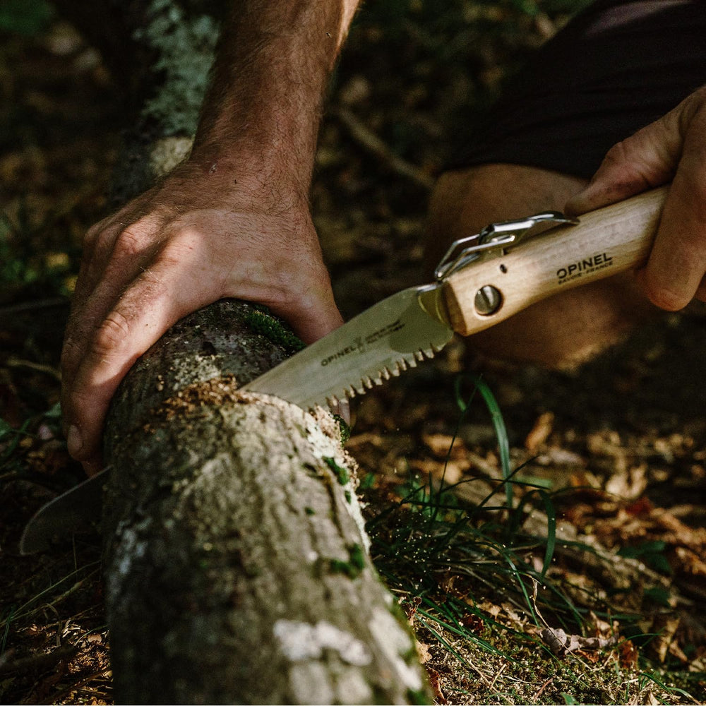 OPINEL saw cutting a branch outdoors, fast pruning made simple