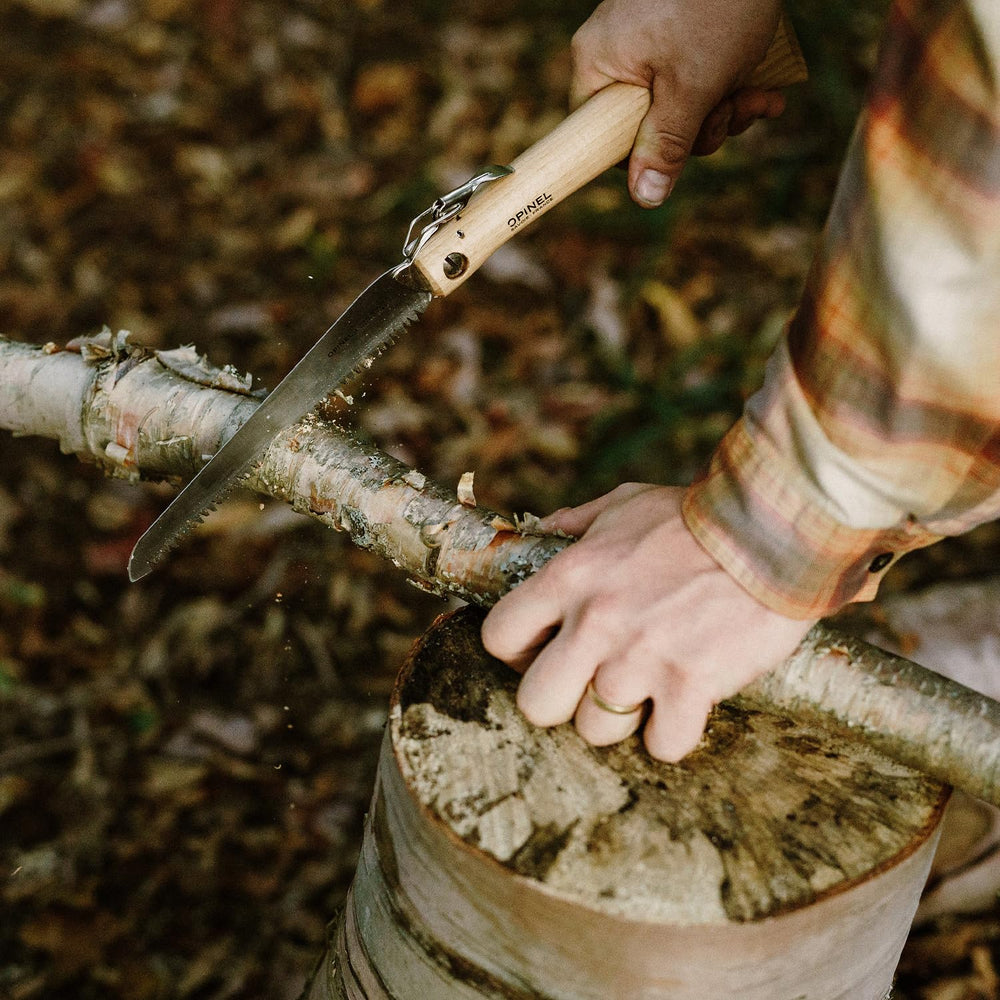 OPINEL saw laid on camping gear illustrating portable camp tool benefits
