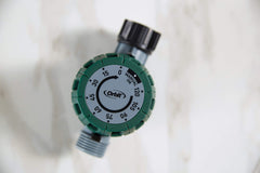 Orbit attached to outdoor spigot in use delivering timed watering without batteries