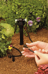 Orbit manifold installed in garden riser feeding four drip lines for precise water delivery