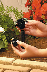 Orbit manifold held in hand for scale showing compact size and quick installer benefit