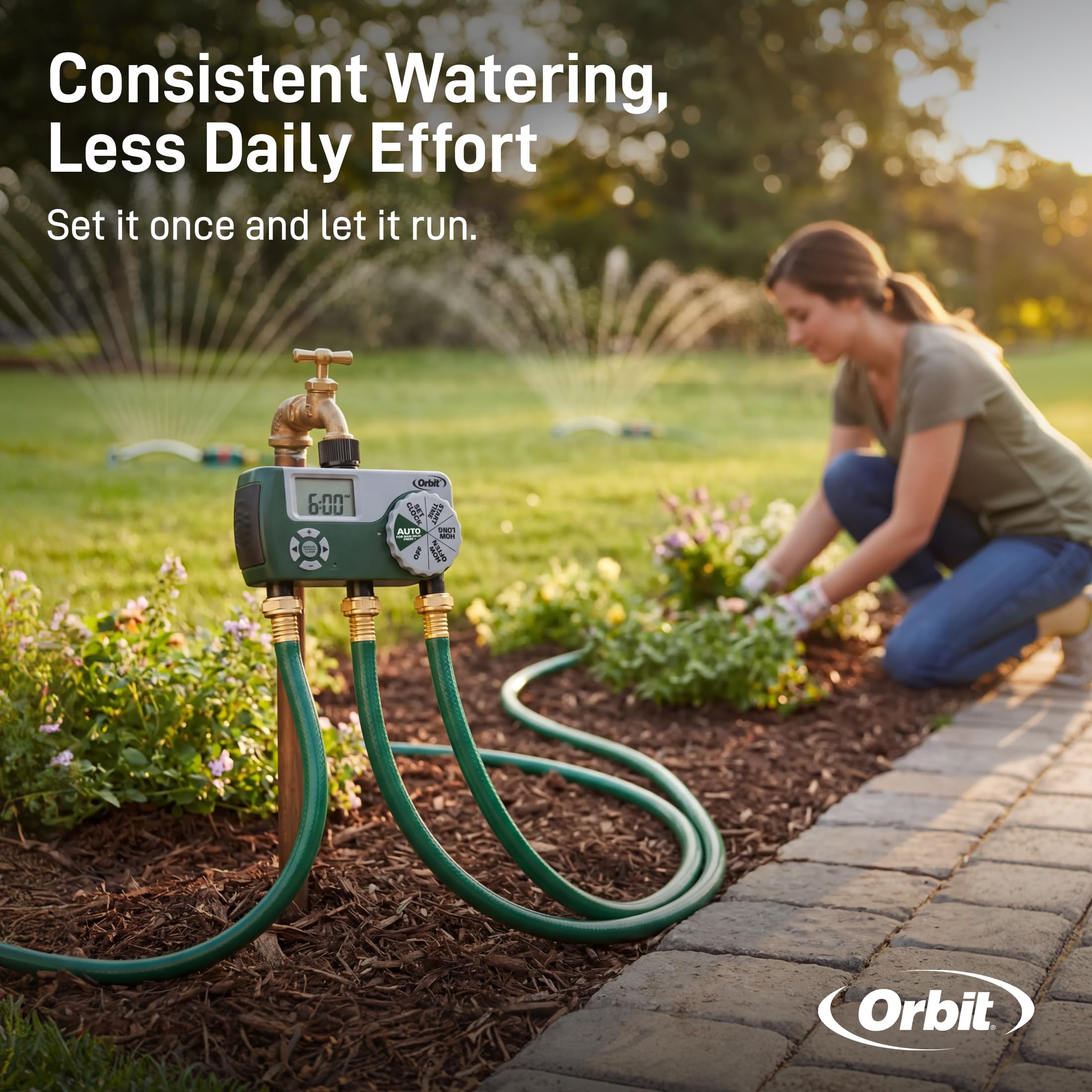 Orbit powering three hoses across a landscaped yard for efficient multi-area watering
