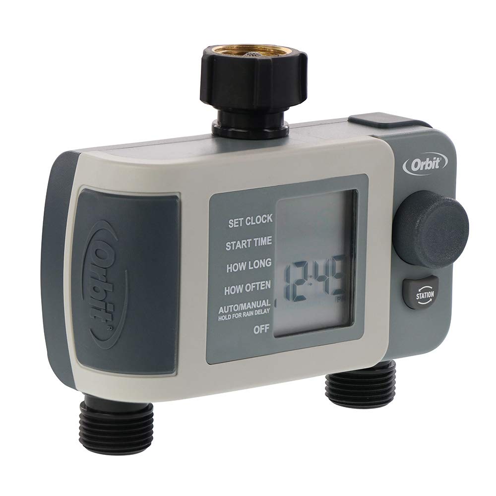 Orbit timer attached to faucet with two hoses watering garden beds for consistent care