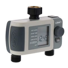 Orbit timer attached to faucet with two hoses watering garden beds for consistent care