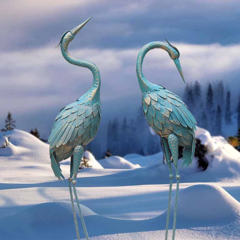 Oritty cranes beside pond enhancing landscape contrast and interest