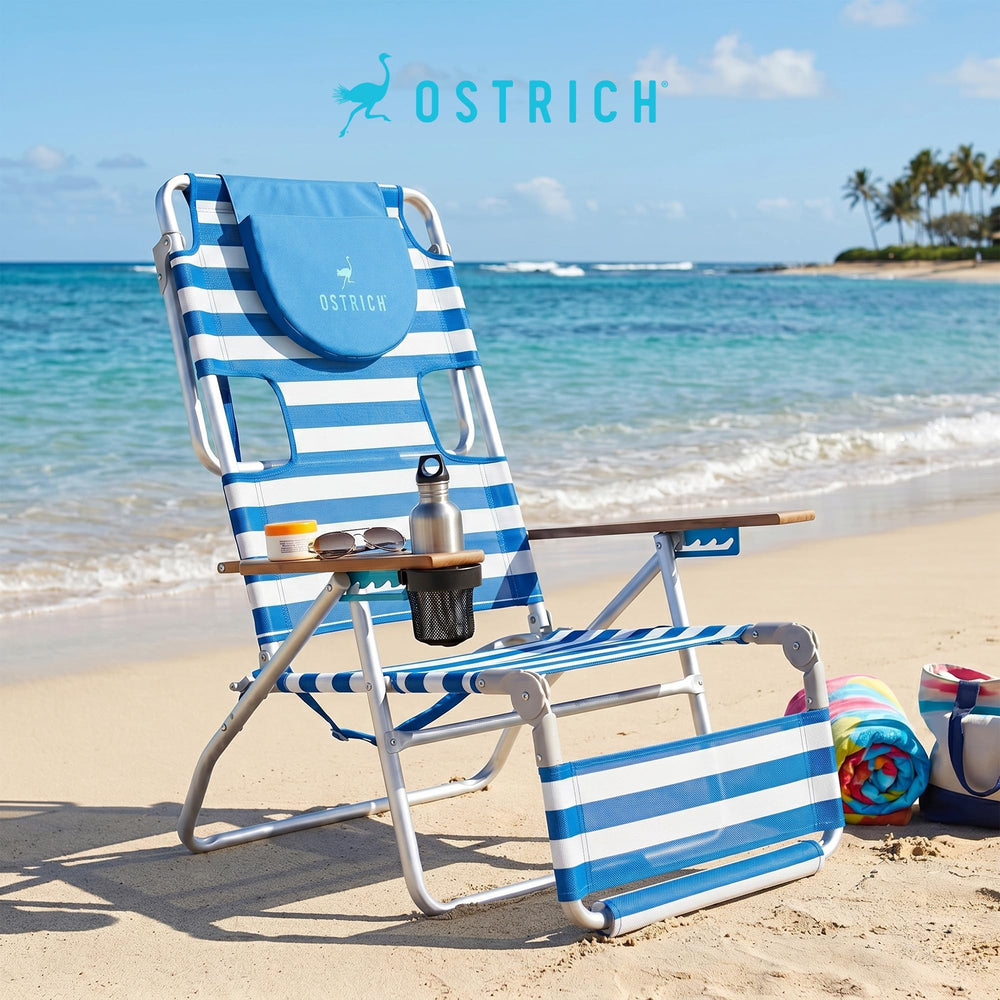 Ostrich in beach setting with towel and umbrella demonstrating relaxed outdoor use