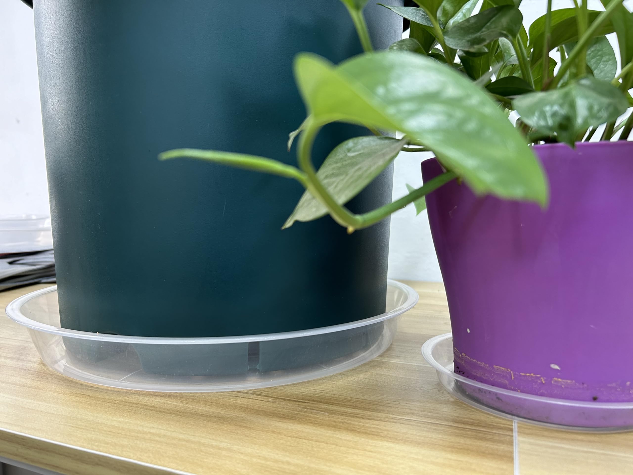 OUPSAUI saucer holding a large planter on a patio to prevent stains