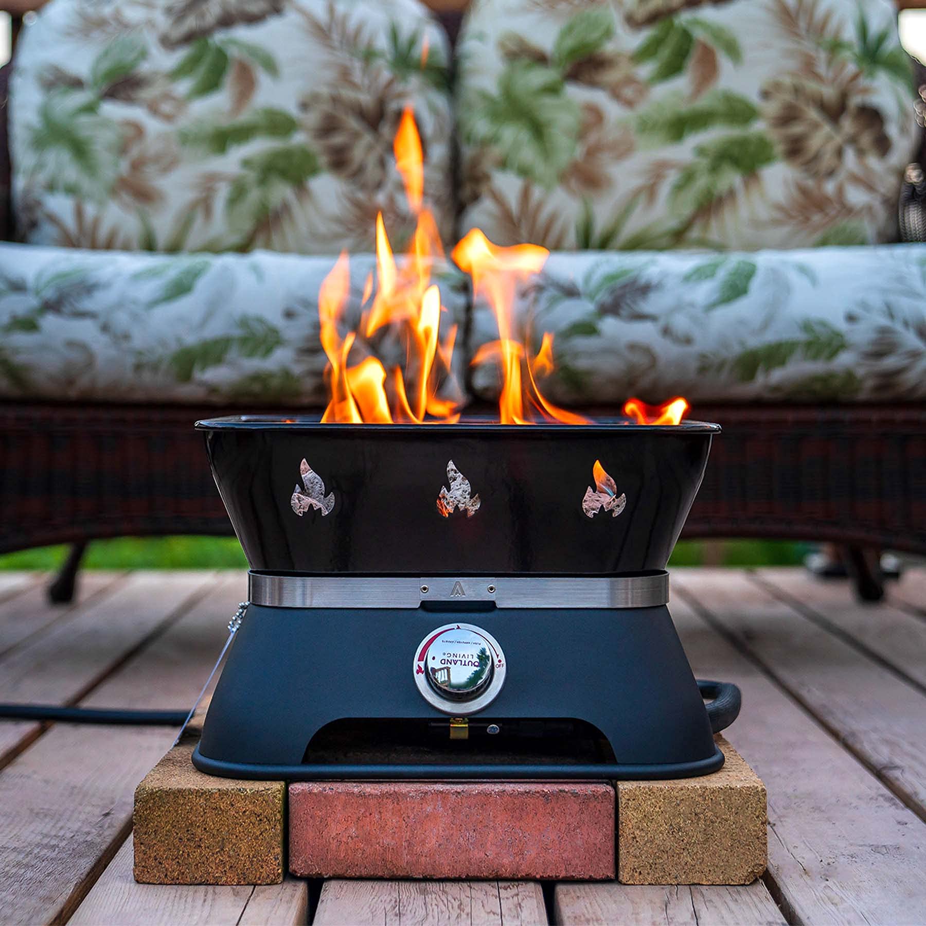 Outland Living Firecube on patio at night creating cozy atmosphere for social evenings