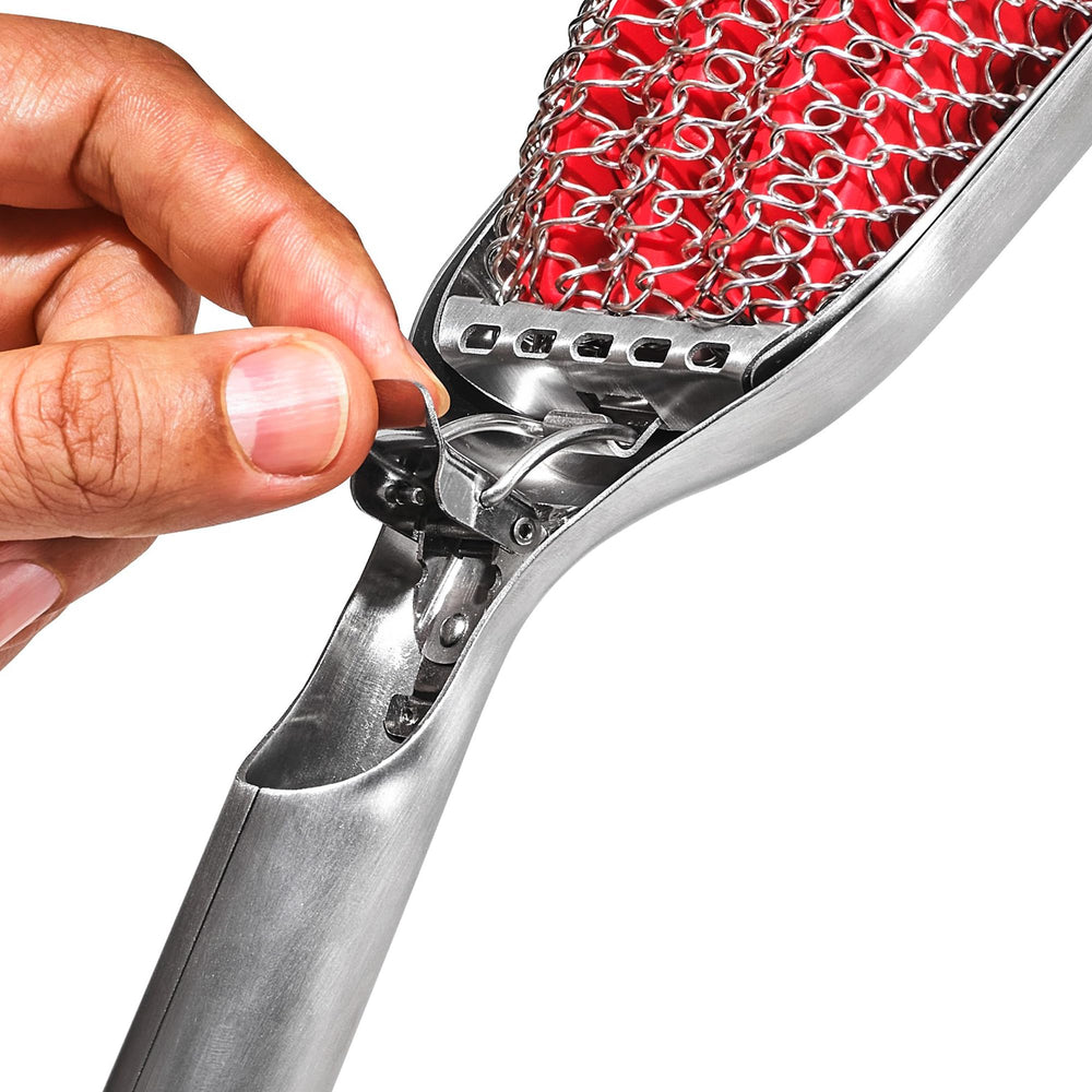 OXO metal scraper close-up demonstrating cut-outs that dislodge stuck-on food