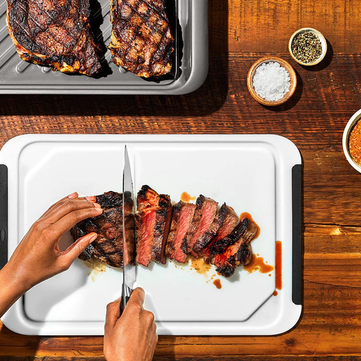 オクソアウトドア in use next to grill, speeds outdoor prep benefit