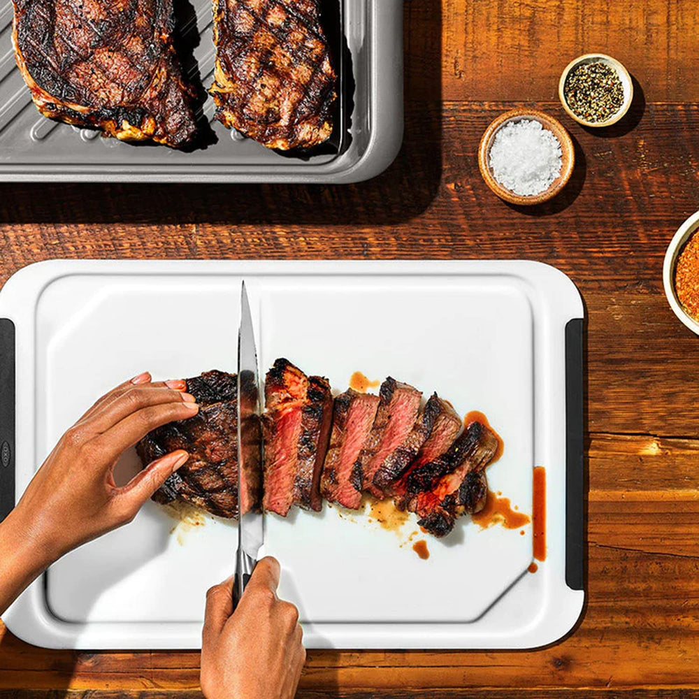オクソアウトドア in use next to grill, speeds outdoor prep benefit