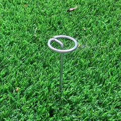 Palmhomee staples driven into soil demonstrating strong hold benefit