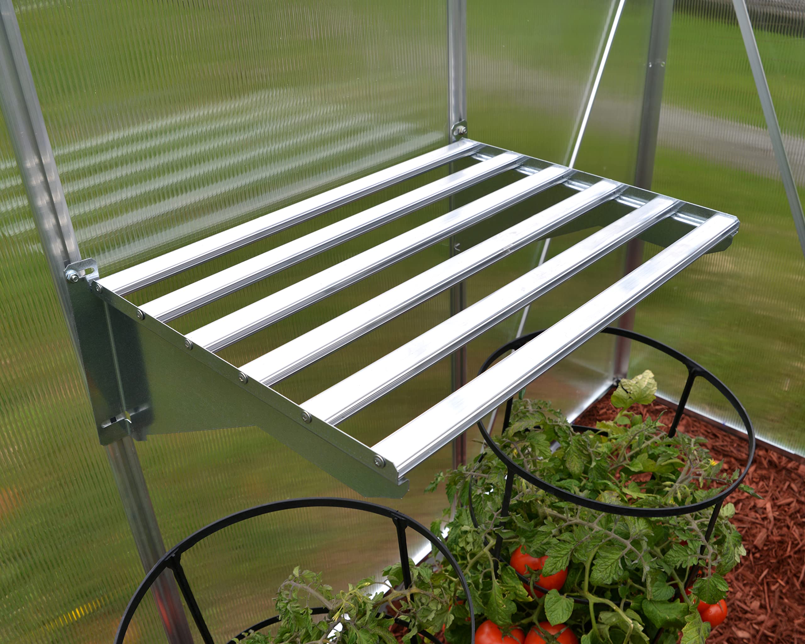 Palram shelf mounted in greenhouse demonstrating space-saving plant staging benefit