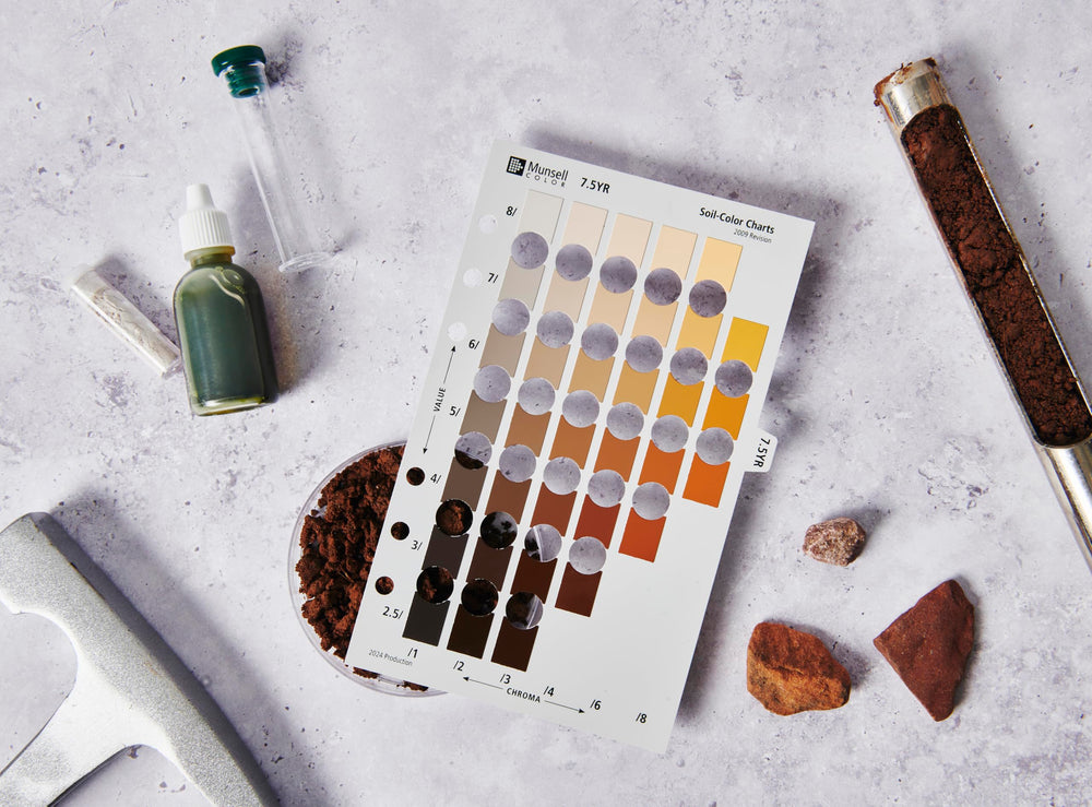 Pantone Munsell book held at a dig site matching soil color, aiding quick field recording