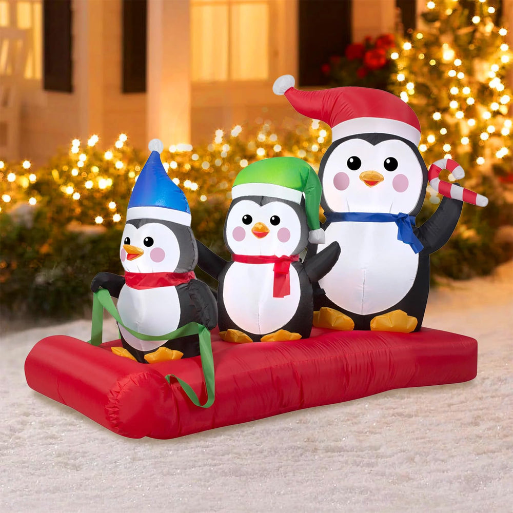 PARAYOYO front view of penguin family on sled bright holiday centerpiece