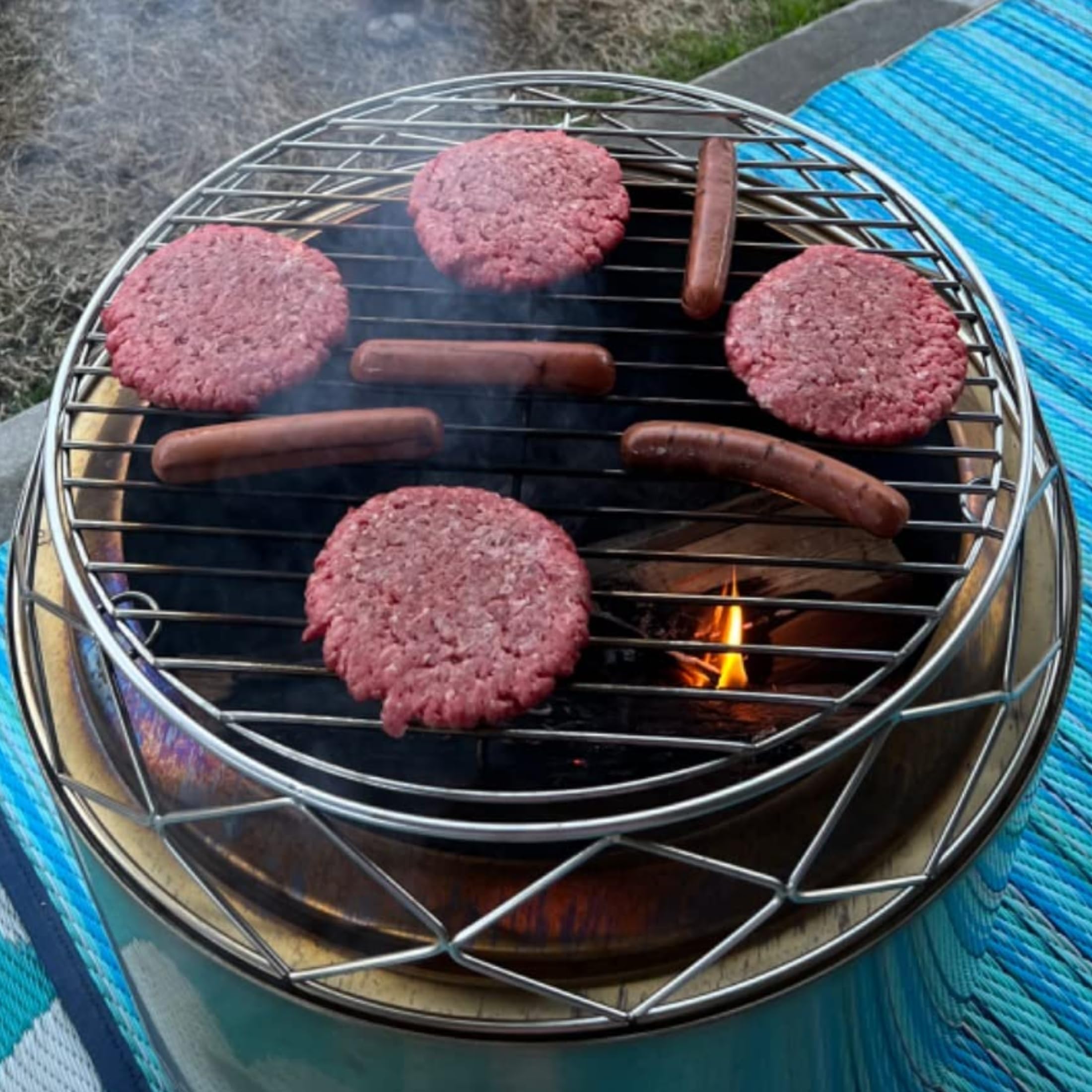 PARTAKER backyard evening scene with stand and grill for versatile outdoor cooking