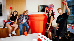 Party Poofer staked on lawn with ropes and water bags for steady outdoor stability