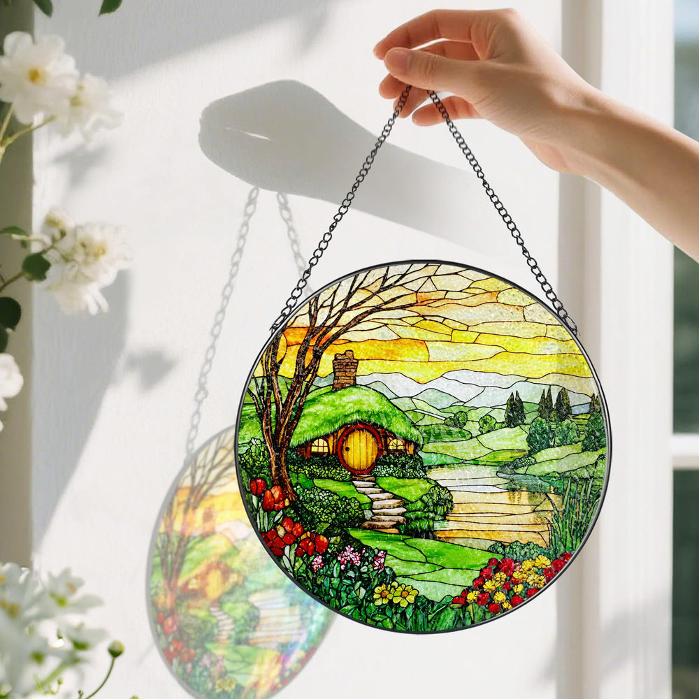 Pauyadu suncatcher hanging in a sunlit window casting rainbow reflections for added warmth