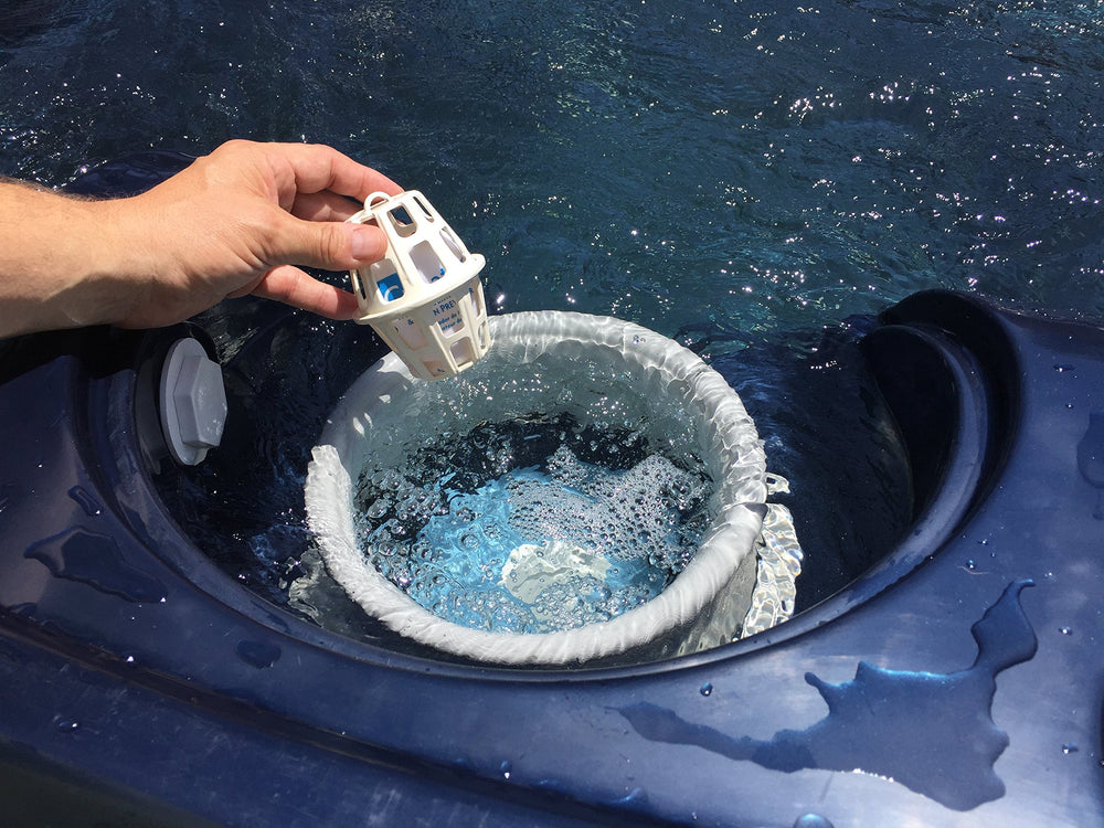 Periodic Products SpaPak placed in skimmer demonstrating easy drop‑in maintenance