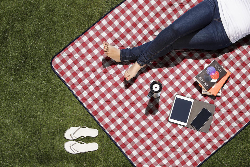 PICNIC TIME folded blanket next to water bottle showing compact travel size