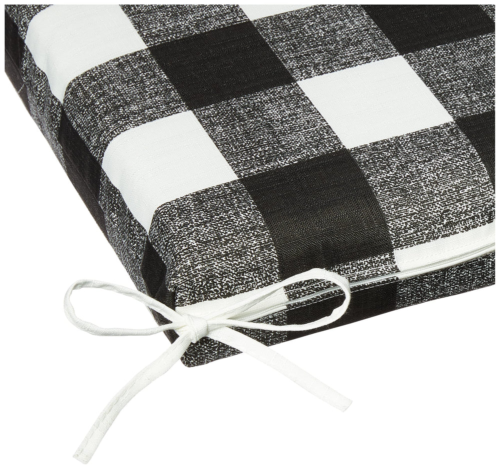 Pillow Perfect cushion in use on a porch bench demonstrating comfort and weather-ready style