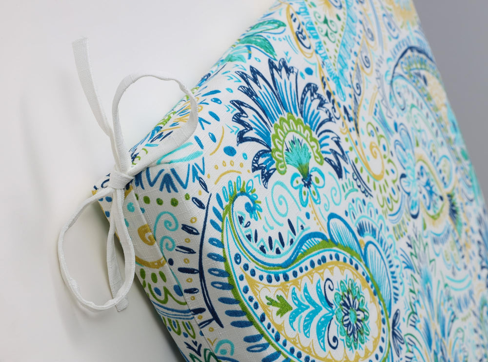 Pillow Perfect Gilford placed on patio chair demonstrating outdoor use comfort