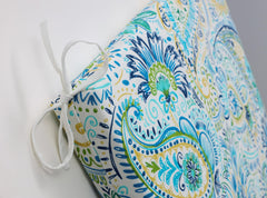 Pillow Perfect Gilford placed on patio chair demonstrating outdoor use comfort