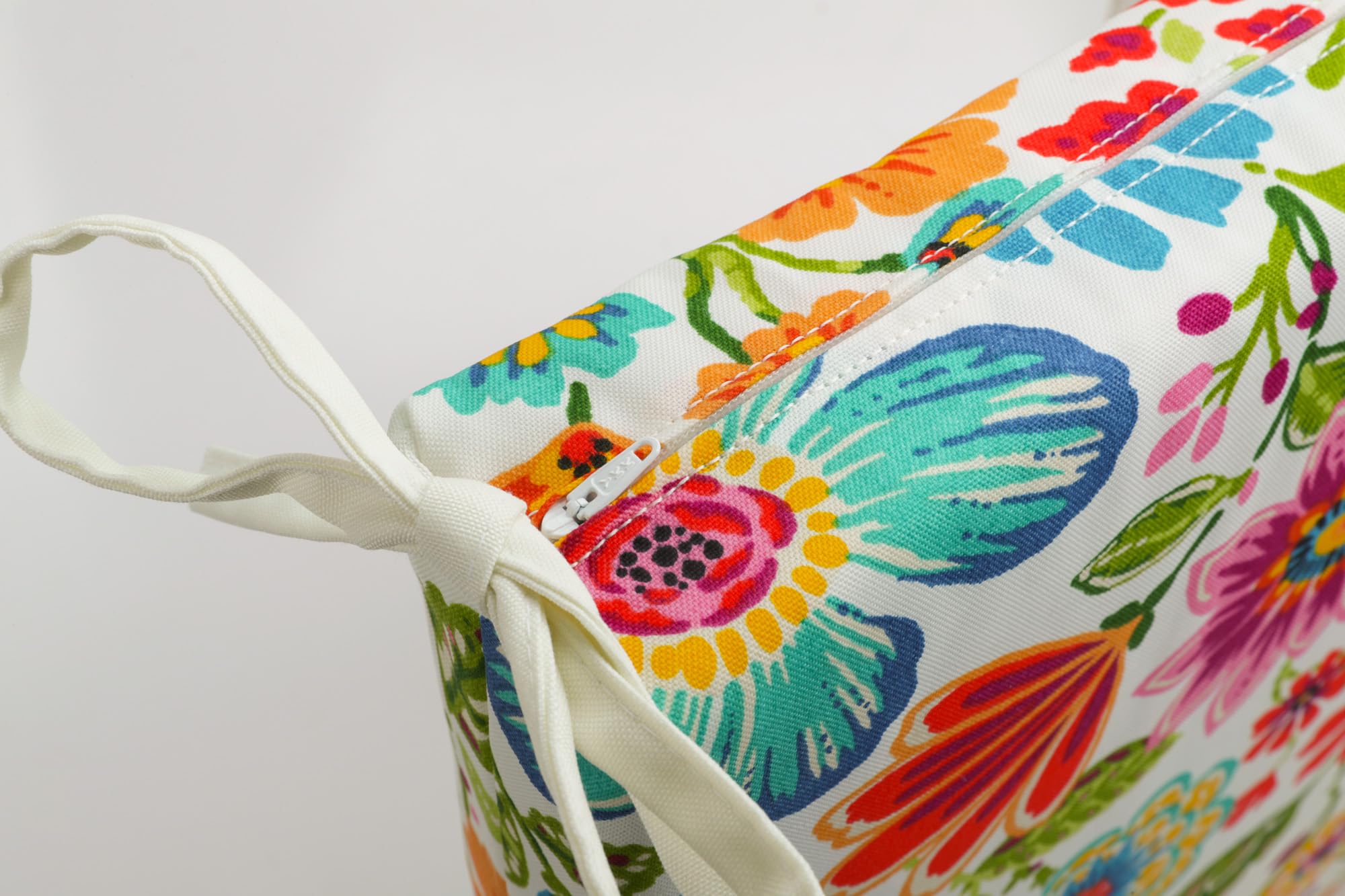 Pillow Perfect cushion positioned on a patio bench adding color and comfort