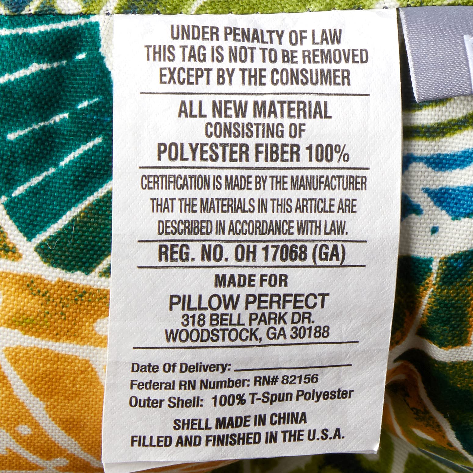 Pillow Perfect Omnia Lagoon cushion in patio setting on wicker loveseat showing stylish comfort